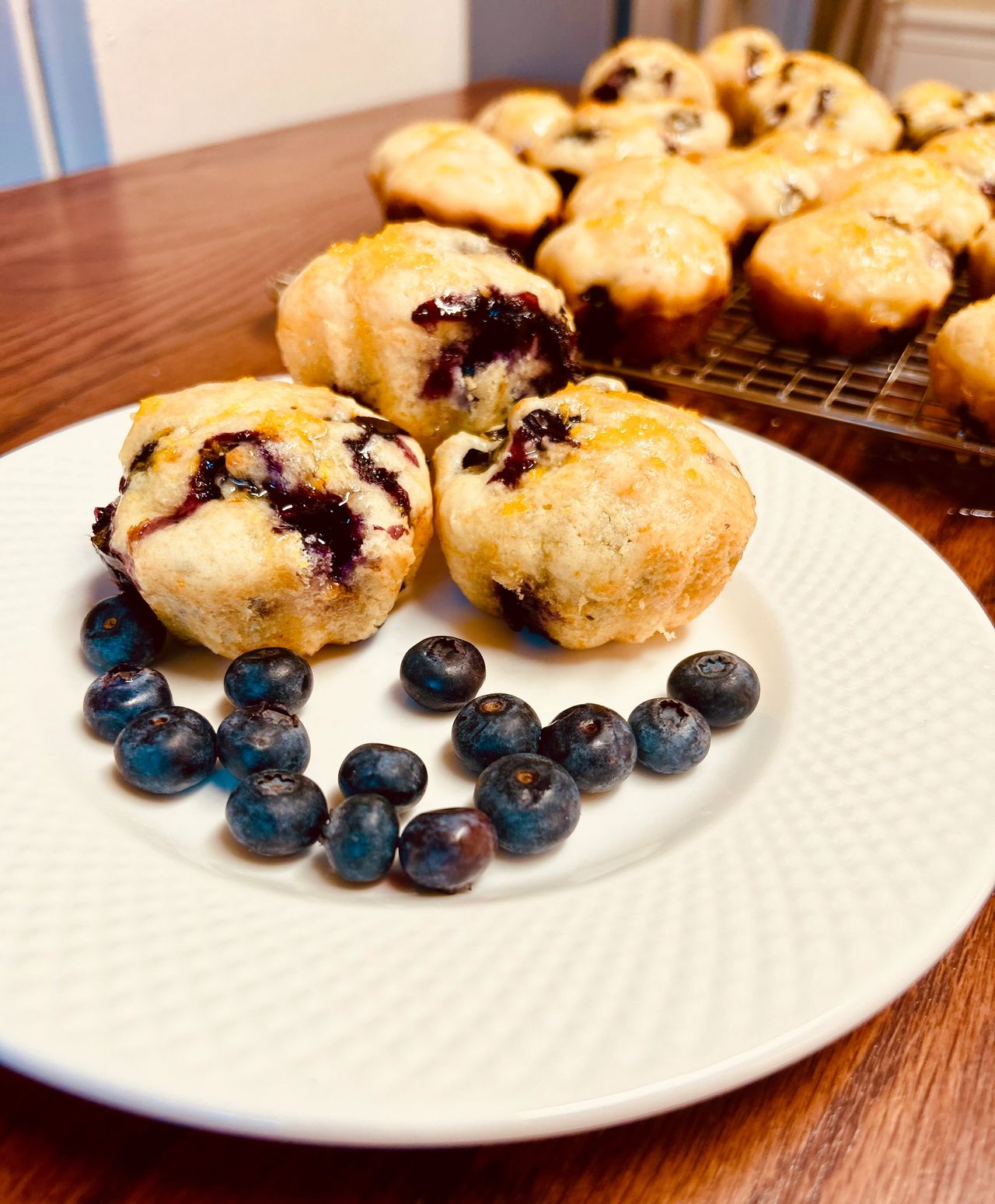 Buttermilk Blueberry Muffins on a plate with blueberries