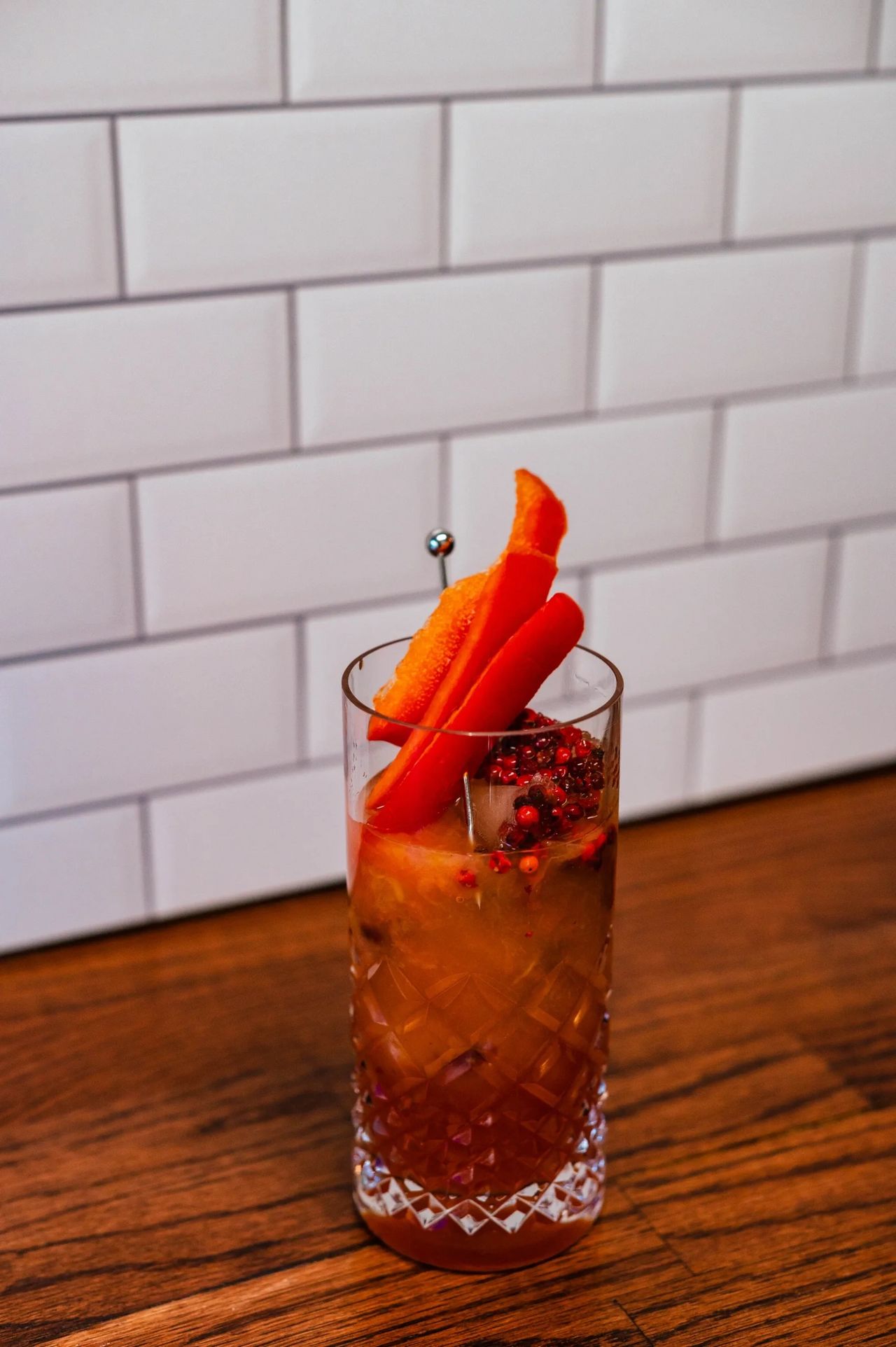 Red Bell Pepper Paloma with Pink Peppercorn ice cubes and red bell pepper garnish. Claire Keathley Photography