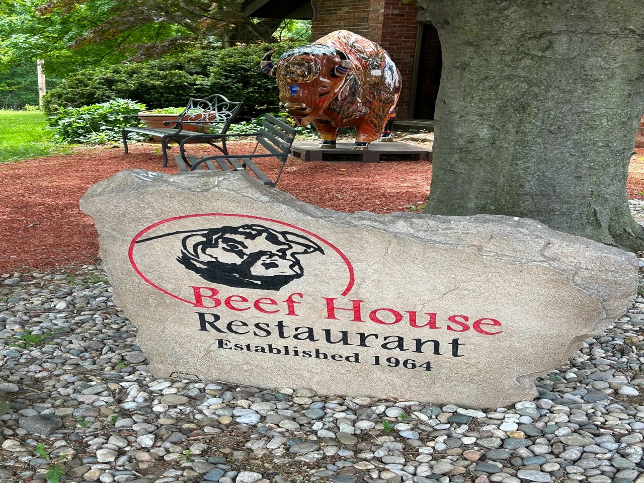 Sign of Beef House Restaurant with large buffalo cow in the background