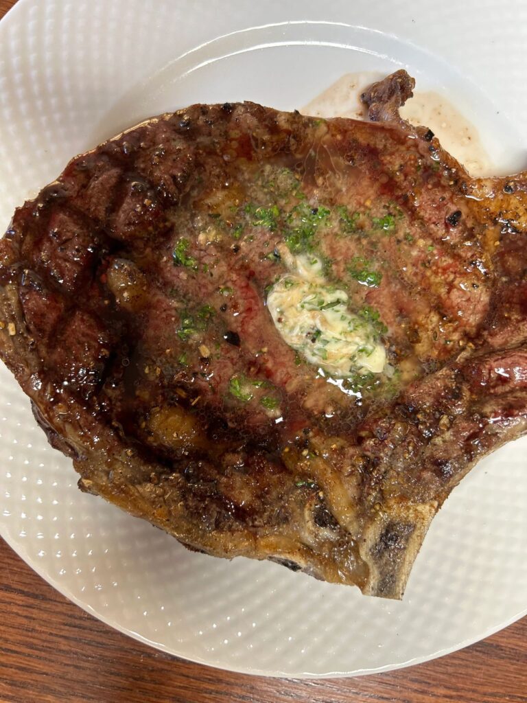 Perfectly cooked steak with dollop of herb butter