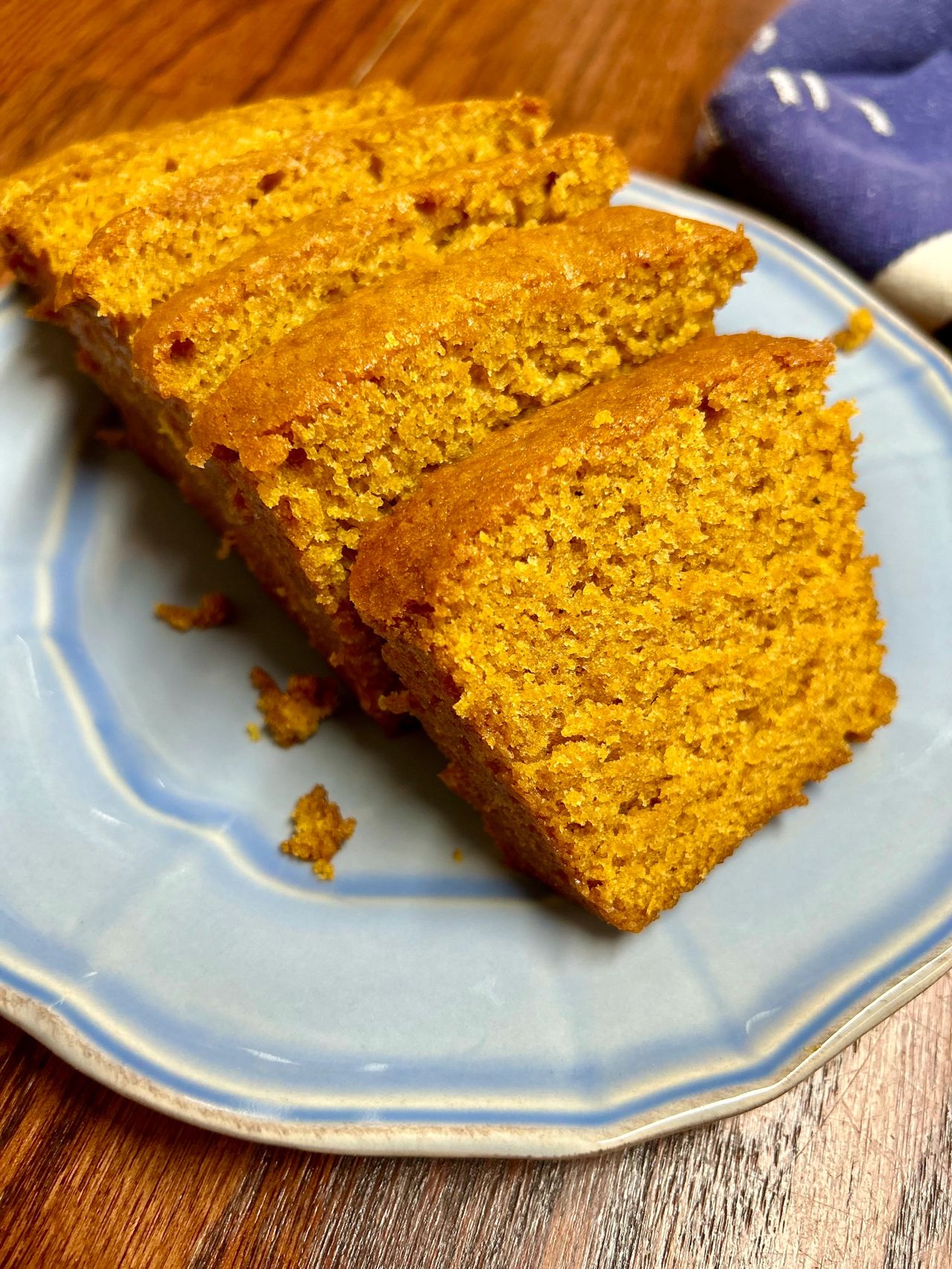 Slices of pumpkin bread on a blue plate.