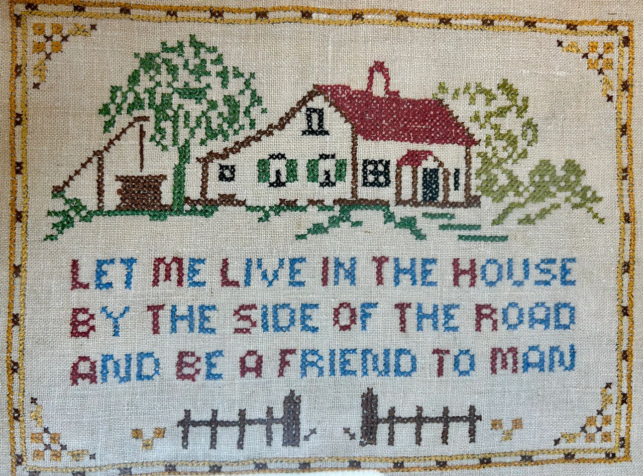 Vintage cross-stitch with saying Let me live in the house by the side of the road and be a friend to man
