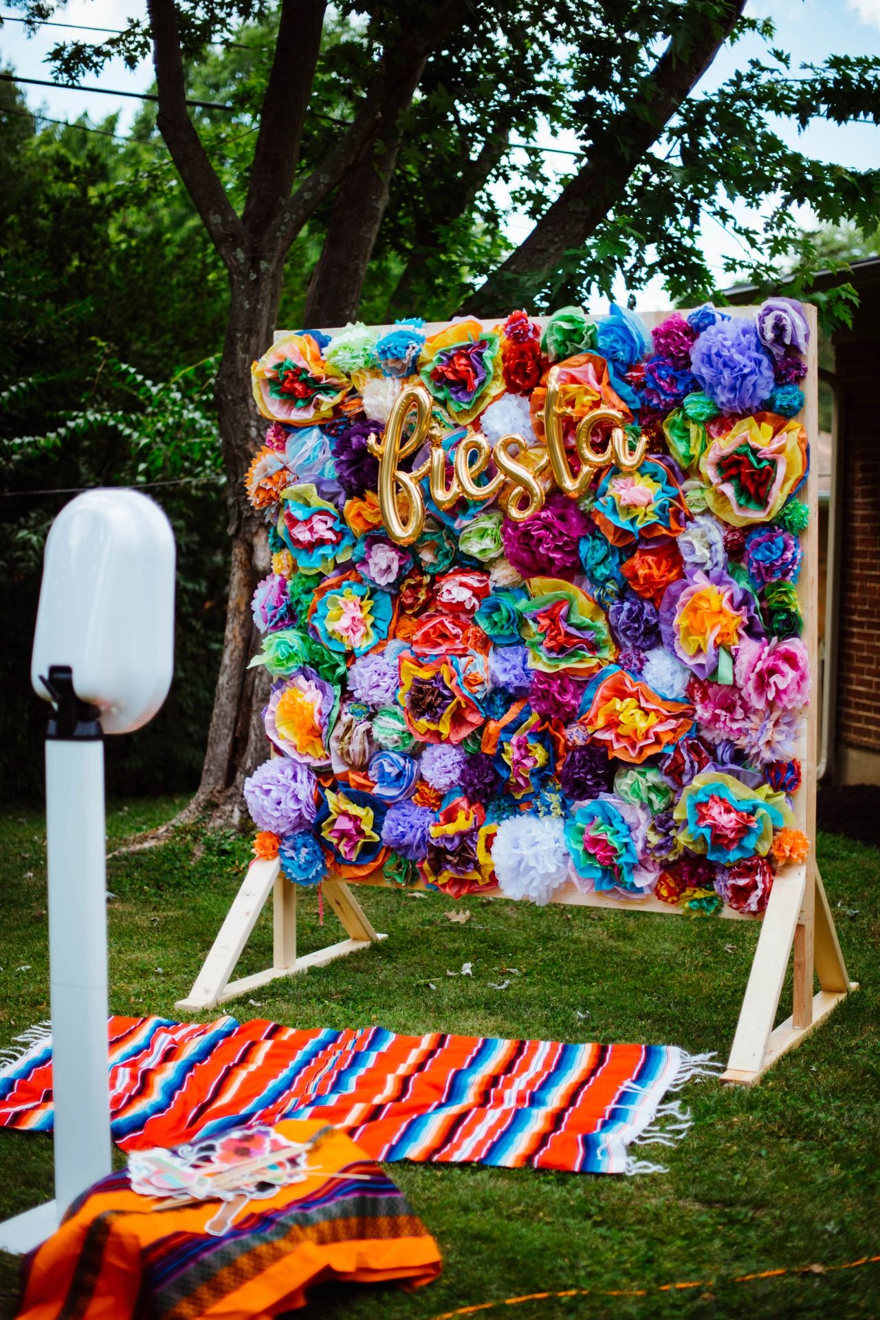 Photo Booth made of tissue paper flowers and fiesta balloon sign