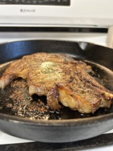 A perfectly cooked steak in a cast-iron skillet.