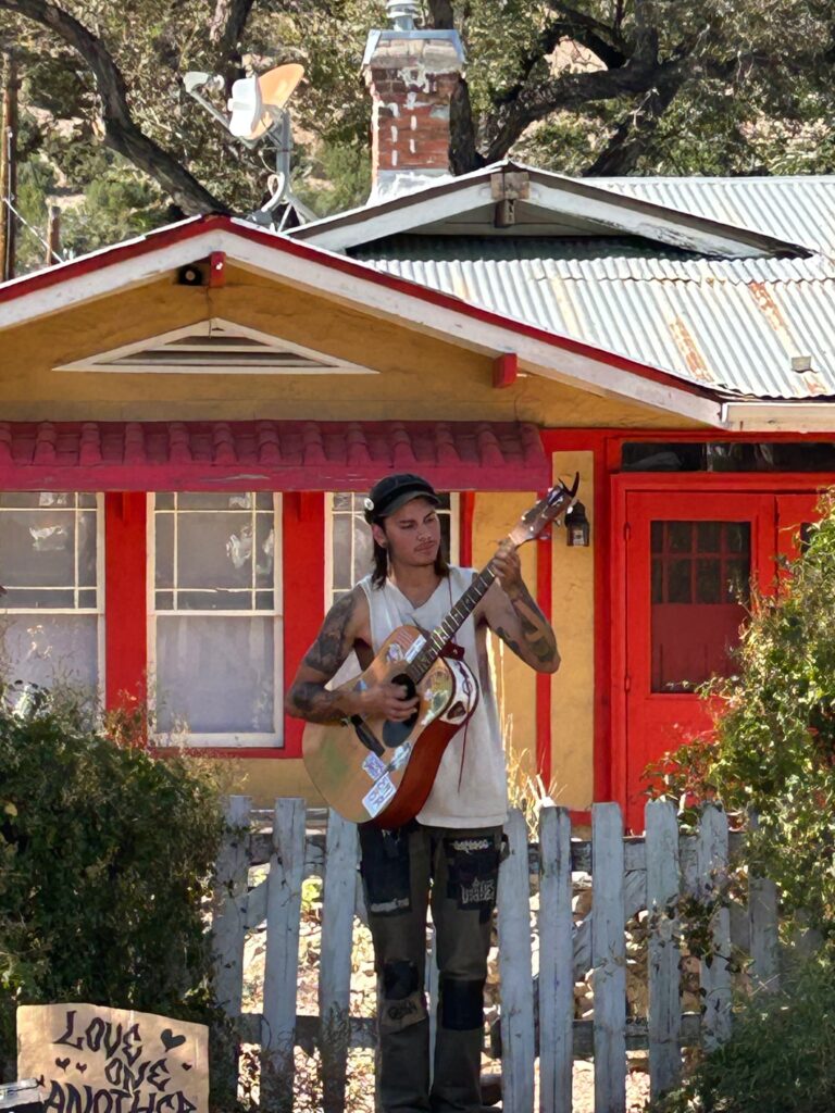 Person playing guitar in Madrid, NM