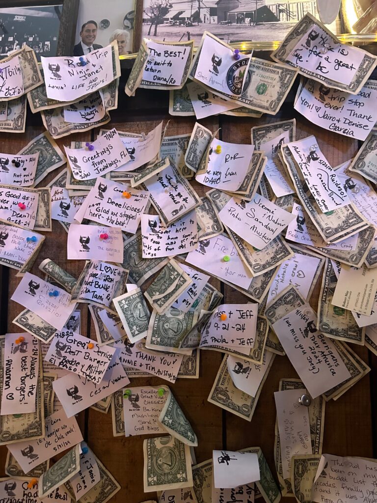 Notes and dollar bills pinned to wall