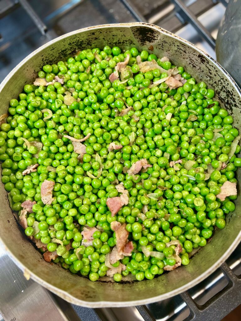 Black pepper and bacon green peas in pan