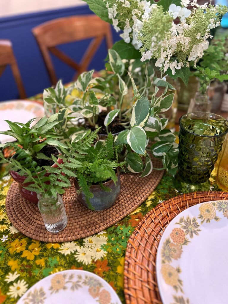 Ferns and cuttings from the garden in the center of a spring table