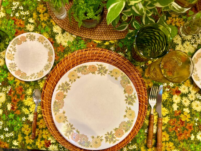 Place setting with vintage yellow and green plates and linens.