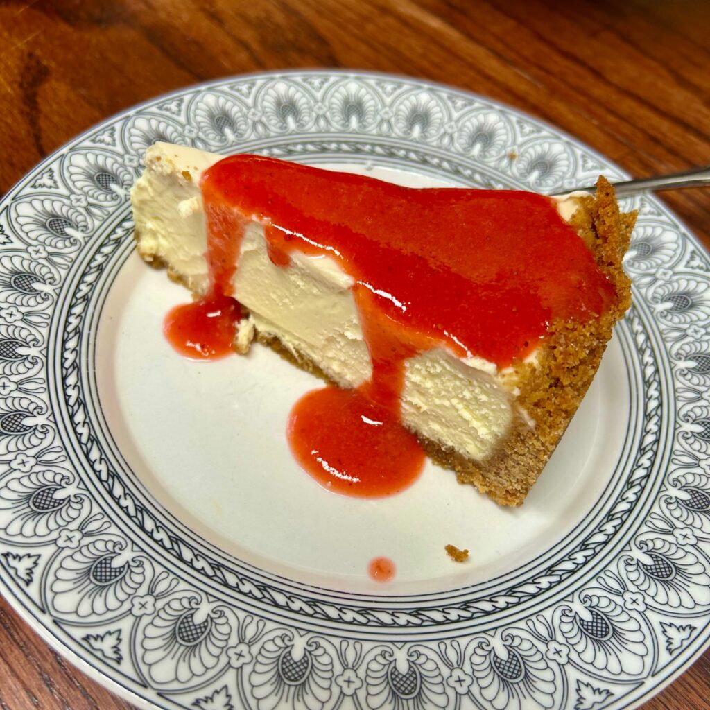 Cheesecake slice with strawberry sauce