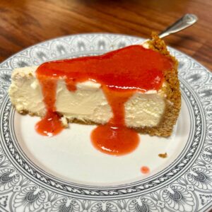 Cheesecake on plate with strawberry sauce