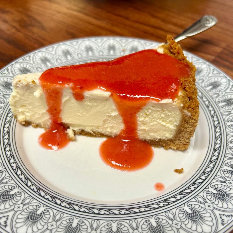 Cheesecake on plate with strawberry sauce